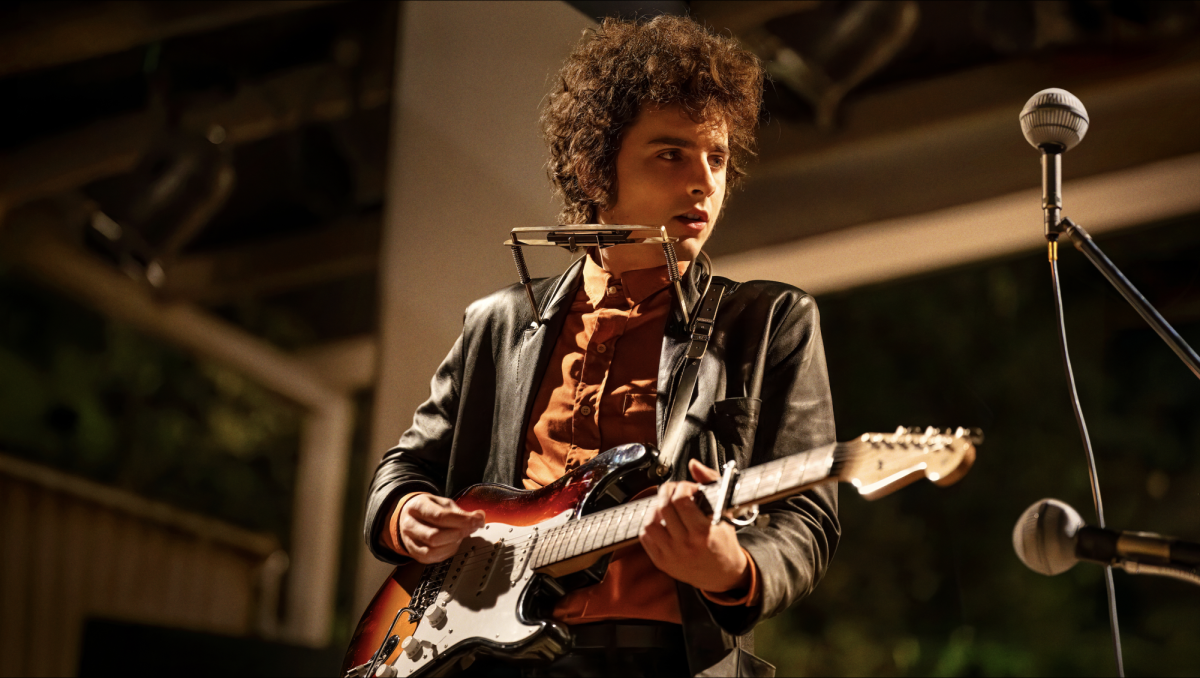 Bob Dylan (Timothée Chalamet) plays his electric guitar, paving the way into a new realm of American music in "A Complete Unknown. 